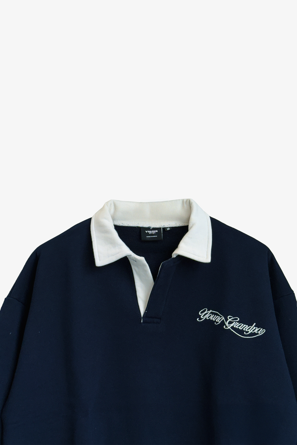 Navy blue shirt with white collar and embroidered logo on a light gray background