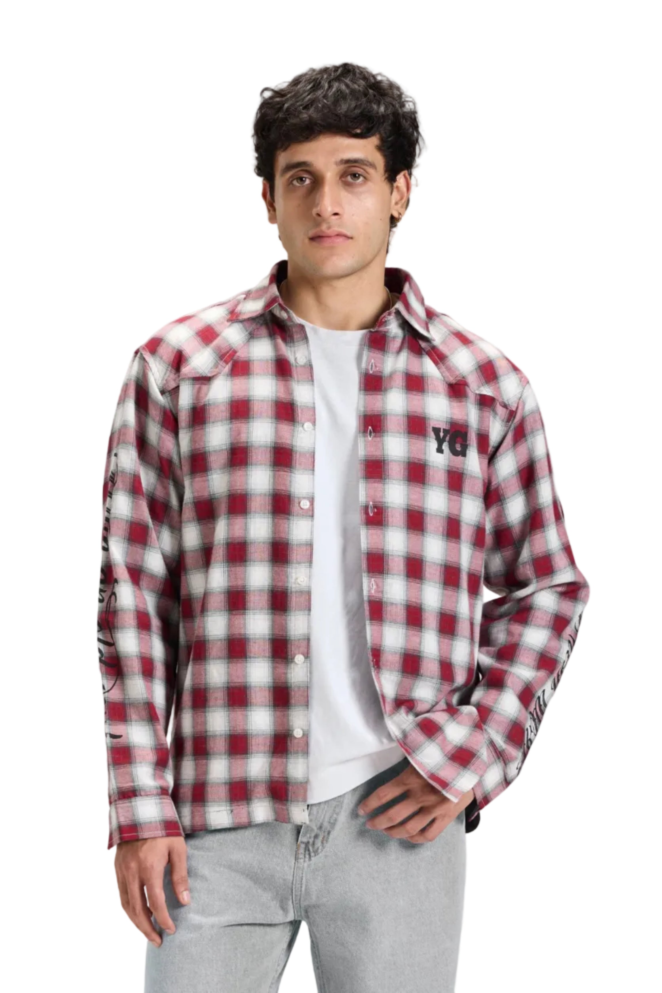 Man wearing a red and white checkered shirt, white t-shirt, gray jeans, and black sneakers on a light gray background